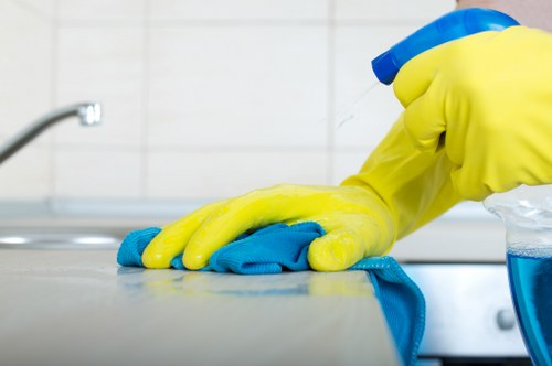 Professional carpet cleaner working safely with PPE and equipment