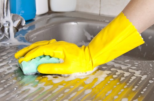 Local cleaner vacuuming and dusting a family home in KT2